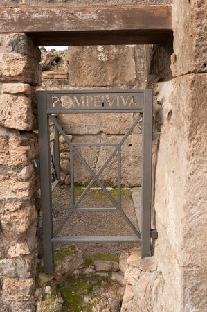 Pompeii, Italy-October 24, 2013:  Modern Pompei Viva gate is used in a doorway in Pompeii, Italyのeditorial素材
