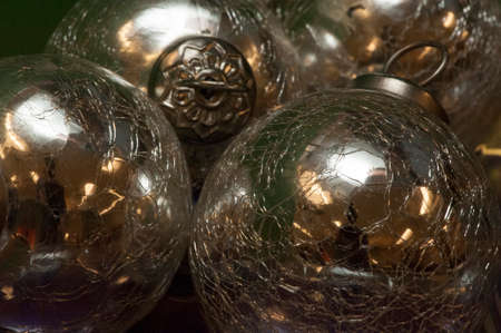 Bright, shiny, silver-colored metallic balls or Christmas decorations are viewed close-up and in a small grouping.の写真素材
