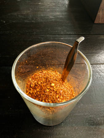 cayenne pepper in glass on a wooden table