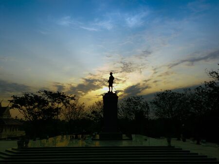 soft focuslights Sillhouette The  King Chulalongkorn statue with sun rise in morning lightの写真素材