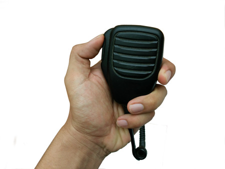 Man's hand holding Handheld microphone for walkie-talkie isolated on a white backgroundの写真素材