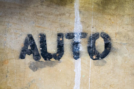 Text "AUTO" by spraying on the cement wall.の写真素材
