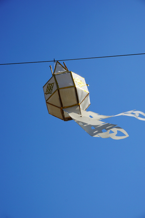 white and gold local hand craft lantern with blue sky backgroundの写真素材