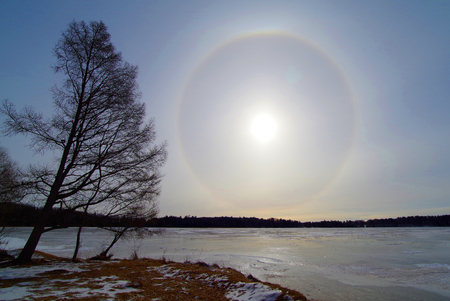 Full solar halo over a frozen lake in Northern Minnesotaの写真素材