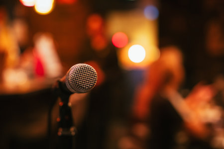 Microphone on stage in a night club or conference room. Blurred background.の写真素材