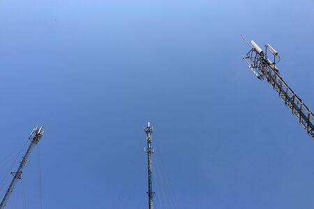 Three telephone pole, view from bottom to top, sky behind.