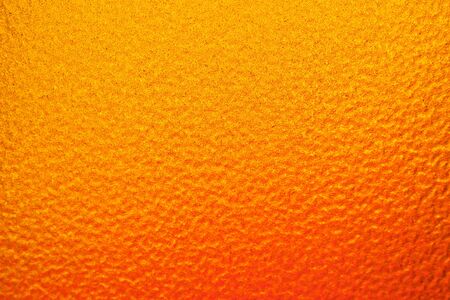 Horizontal image. The background that has only a slight orange shading to a deep yellow color. It have a rough surface.の写真素材