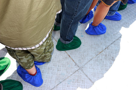 Figure of people standing in line. Everyone was wearing funny green and blue socks.