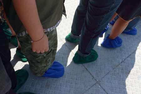 Figure of people standing in line. Everyone was wearing funny green and blue socks.の写真素材