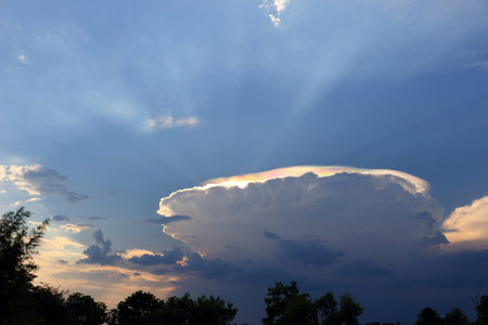 The spherical cloud had a rainbow-like glow above it.