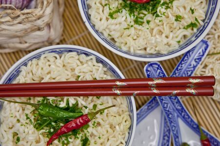 Two bowls with hot asian noodlesの写真素材