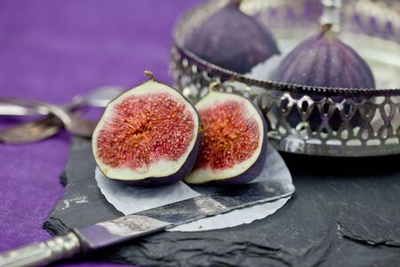 Fresh plums in a vintage silver bowl