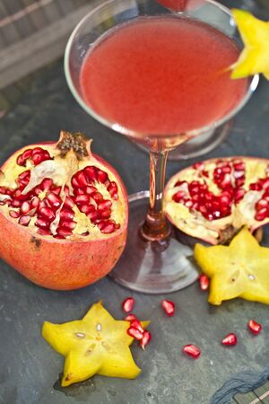 Two glasses with a red cocktail and pomegranateの写真素材
