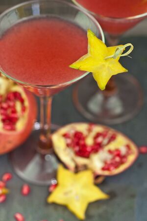Two glasses with a red cocktail and pomegranateの写真素材