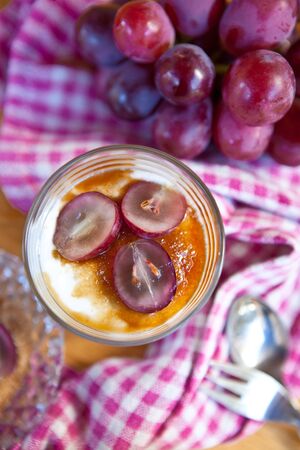 Creamy dessert with red grapesの写真素材