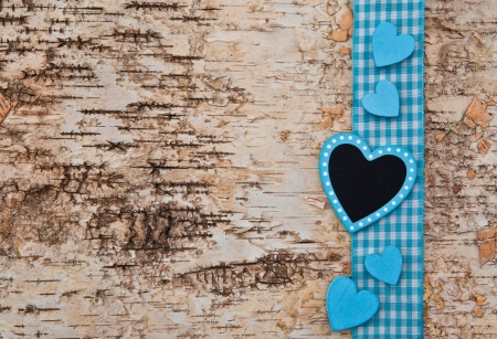 Wooden background with blue checkered ribbon and heartsの写真素材