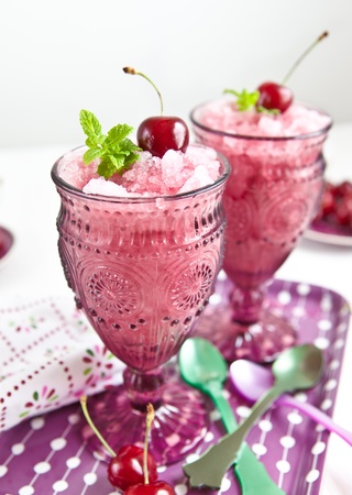 Cold sorbet with cherries and fresh mint leavesの写真素材