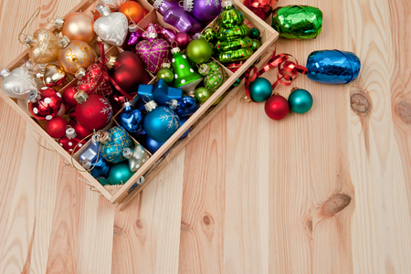 Little wooden box with colorful christmas baublesの写真素材