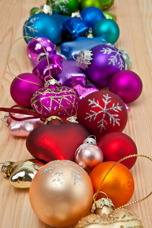 Colorful christmas baubles on a rustic wooden backgroundの写真素材