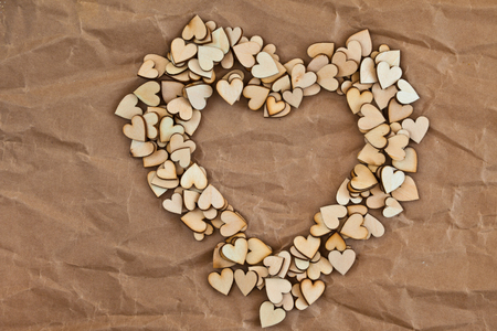 Paper with Heart-shape made from little wooden heartsの写真素材