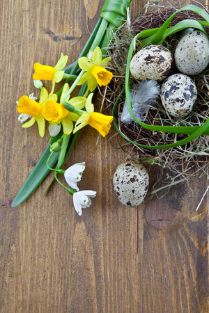 Fresh spring flowers and a rustic easter nestの写真素材