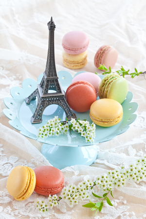 Colorful macaroons on blue plate and a little Eiffeltowerの写真素材