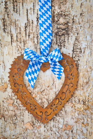Rustic background with bavarian white and blue ribbon and heartの写真素材