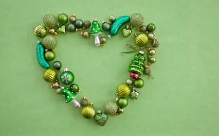 Green christmas baubles arranged in a heart shapeの写真素材