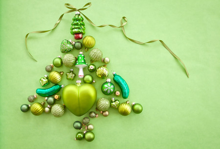 Green christmas baubles arranged in a tree shapeの写真素材