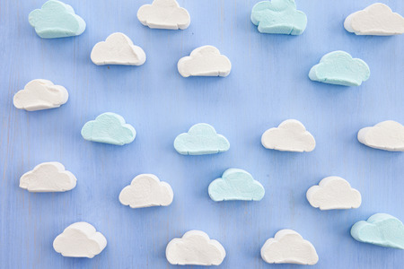 Marshmallows in cloud shapes on blue backgroundの写真素材