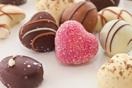 Selection of chocolate candy and truffles in heart shapeの写真素材