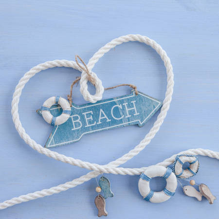 Heart shape made with rope on blue wooden background