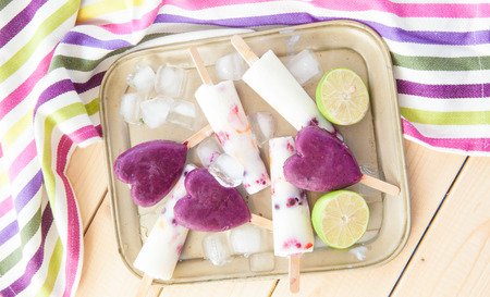 Homemade frozen popsicles with fresh fruits and lime
