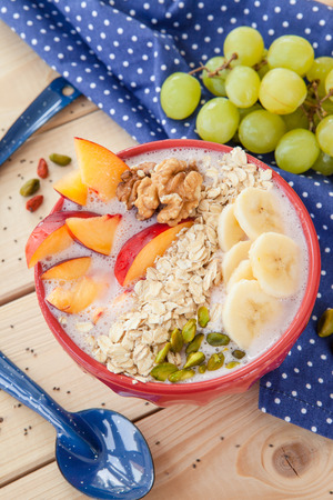 Smoothie Bowl with fresh fruits, nuts and oatmealの写真素材
