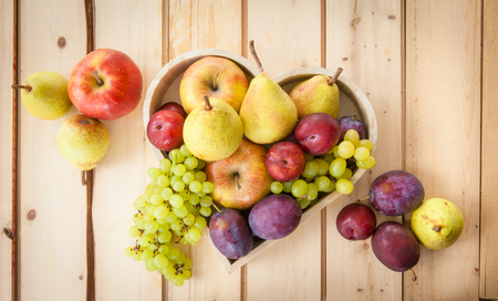 Fresh autumn fruits on a rustic wooden backgroundの写真素材