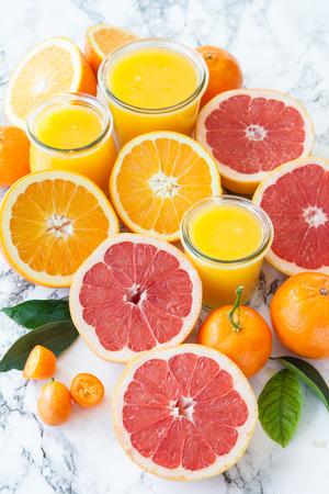 Fresh pressed juice from colorful citrus fruitsの写真素材