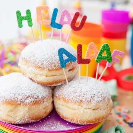 Fresh doughnuts for carnival with colorful party propsの写真素材