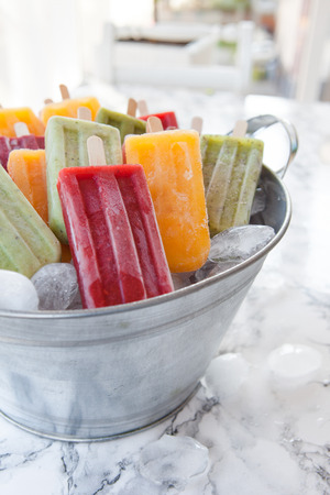 Homemade frozen ice cream popsicles in various flavorsの写真素材