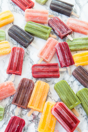 Homemade frozen ice cream popsicles in various flavorsの写真素材