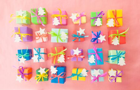 Many colorful gifts wrapped in bright paper with little ribbons