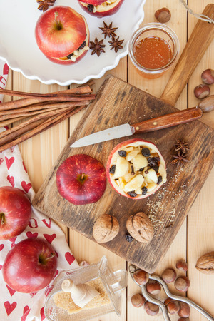 Preparing baked apple with raisins, honey, and cinnamonの写真素材