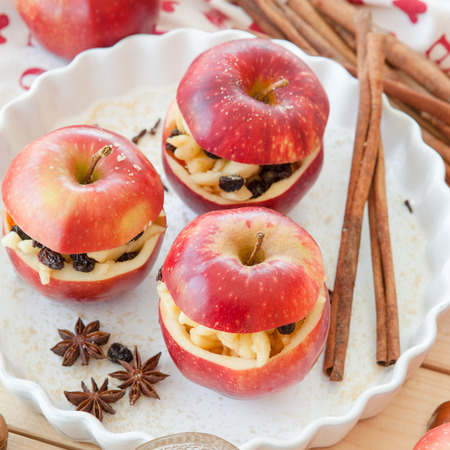 Preparing baked apple with raisins, honey, and cinnamonの写真素材