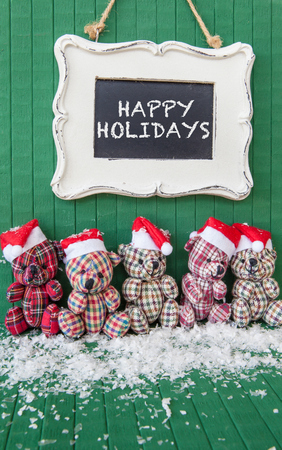 Little teddybears with red Santa Claus hats on Greenの写真素材