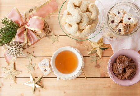 Variety of christmas cookies and a cup of teaの写真素材