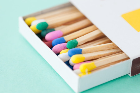 Wooden matches in pastel colors on blueの写真素材