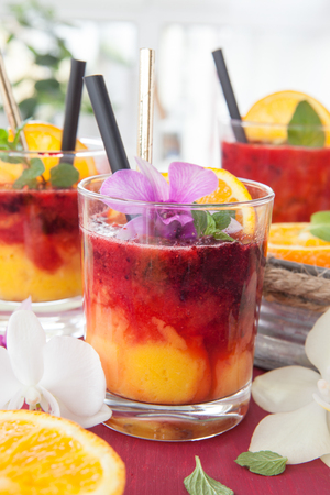 Colorful cocktail with fresh fruits and colorful orchidsの写真素材