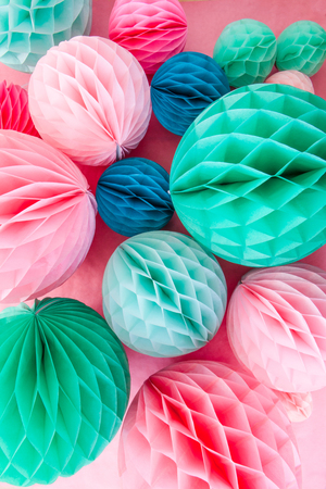 Colorful honeycomb balls on pink for a partyの写真素材