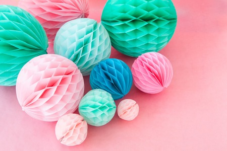 Colorful honeycomb balls on pink for a partyの写真素材