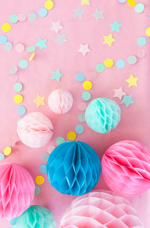 Colorful honeycomb balls on pink for a partyの写真素材