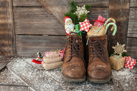 Leather boots with christmas treats and presentsの写真素材